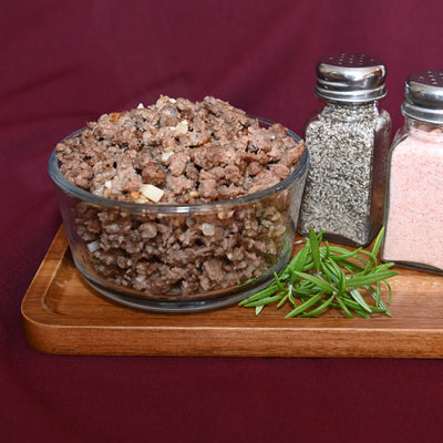 Glass bowl of nicely browned 100% Grass-Fed Ground Beef.